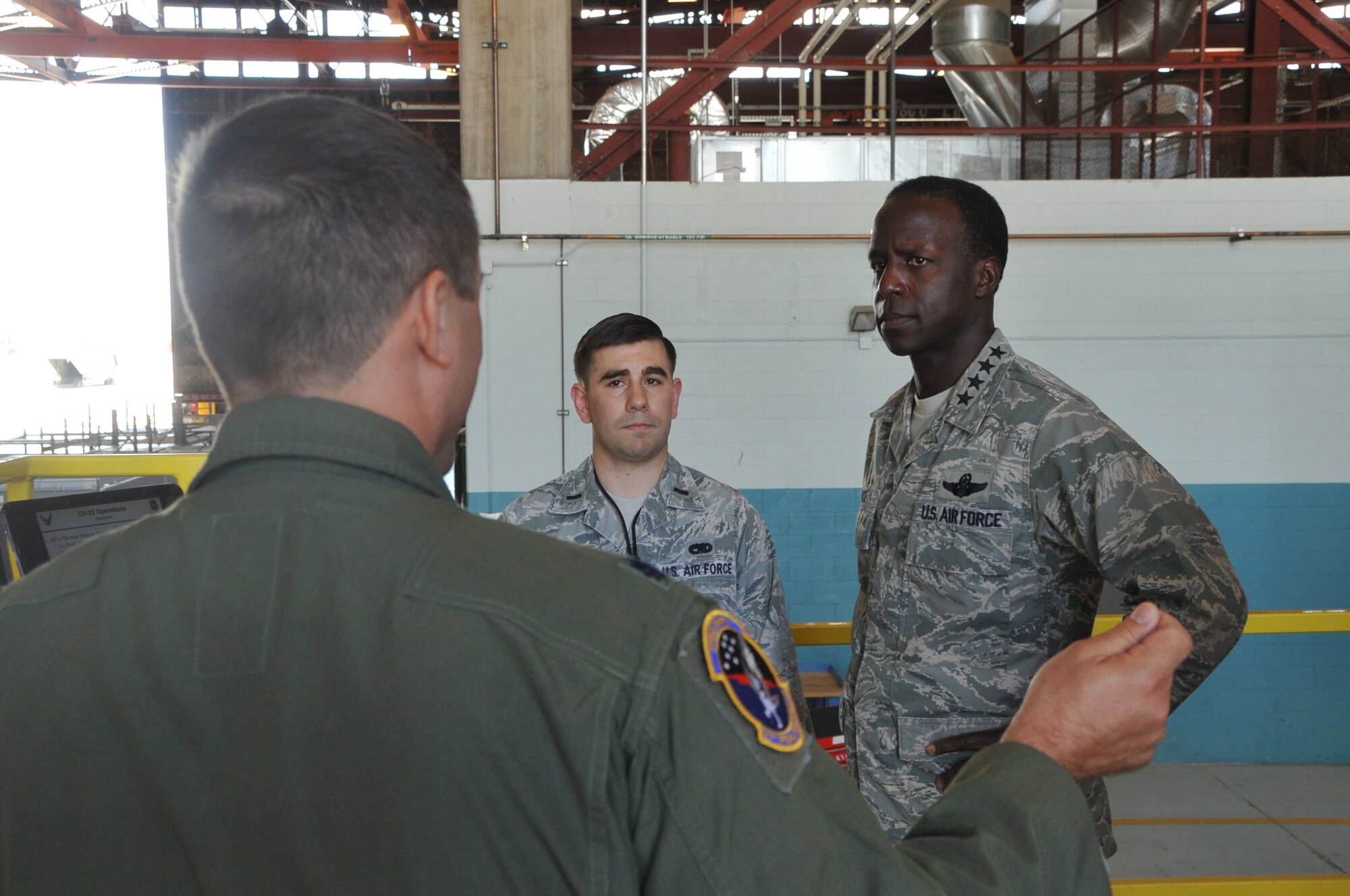 Lt. Col. Steven Breeze, 71st Special Operations Squadron commander, foreground, and 1st Lt. Shawn Cox, 58th Aircraft Maintenance Squadron, center, brief Gen. Edward A Rice Jr., AETC commander, during his visit to Kirtland AFB.