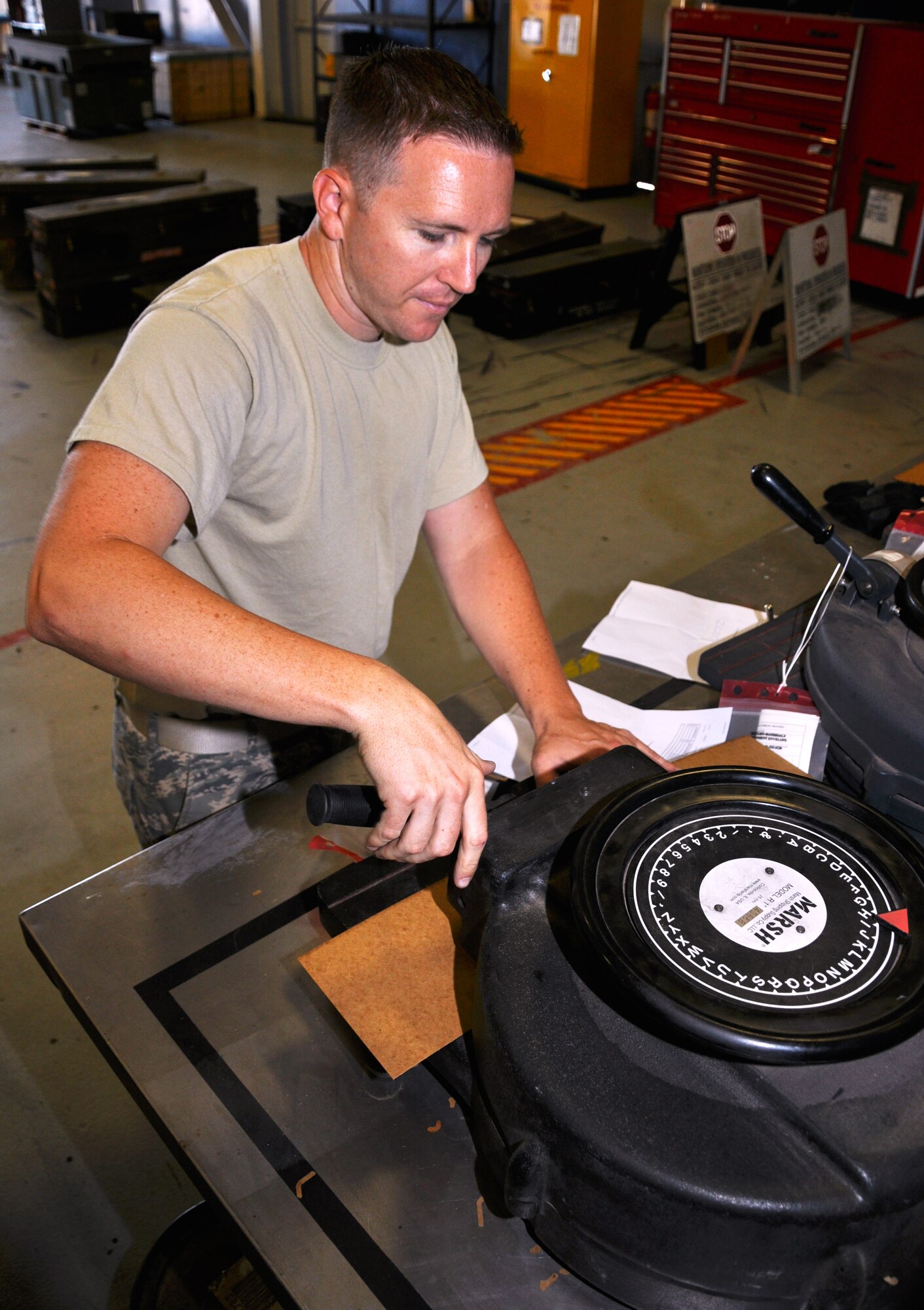 Tech. Sgt. Thadius Putnam, munitions system specialist in the 419th Maintenance Squadron, creates a stencil to label the inert explosives. (U.S. Air Force photo/Airman 1st Class Crystal Charriere)