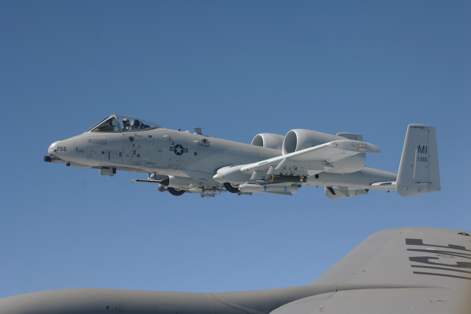 An A-10 Thunderbolt II flies alongside a KC-135 Stratotanker while the A-10’s wingman receives fuel from the tanker, July 21, 2011. All of the aircraft are assigned to the 127th Wing of the Michigan Air National Guard and are based at Selfridge Air National Guard Base, Mich. (USAF photo by John S. Swanson)