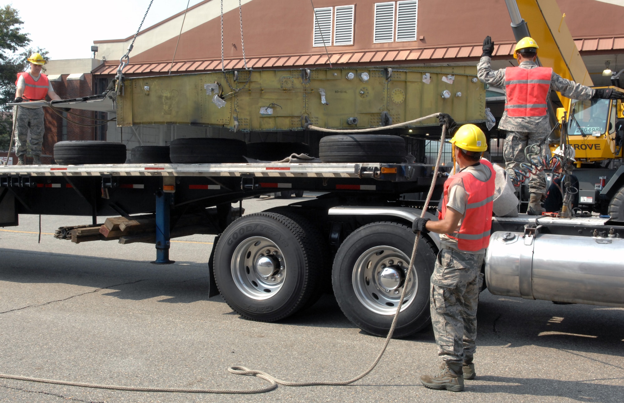 Airmen from the 1st Maintenance Squadron, Maintenance Flight, Package Maintenance and Plan team, use a crane to lift an F-15 Eagle to be secured on a flatbed truck July 21, at Langley Air Force Base, Va. The F-15 will be transported to the Chico Air Museum in Chico, Calif., where it will be on permanent display as part of the “Freedom Eagle” exhibit. (U.S. Air Force photo by Staff Sgt. Jeff Nevison/Released)