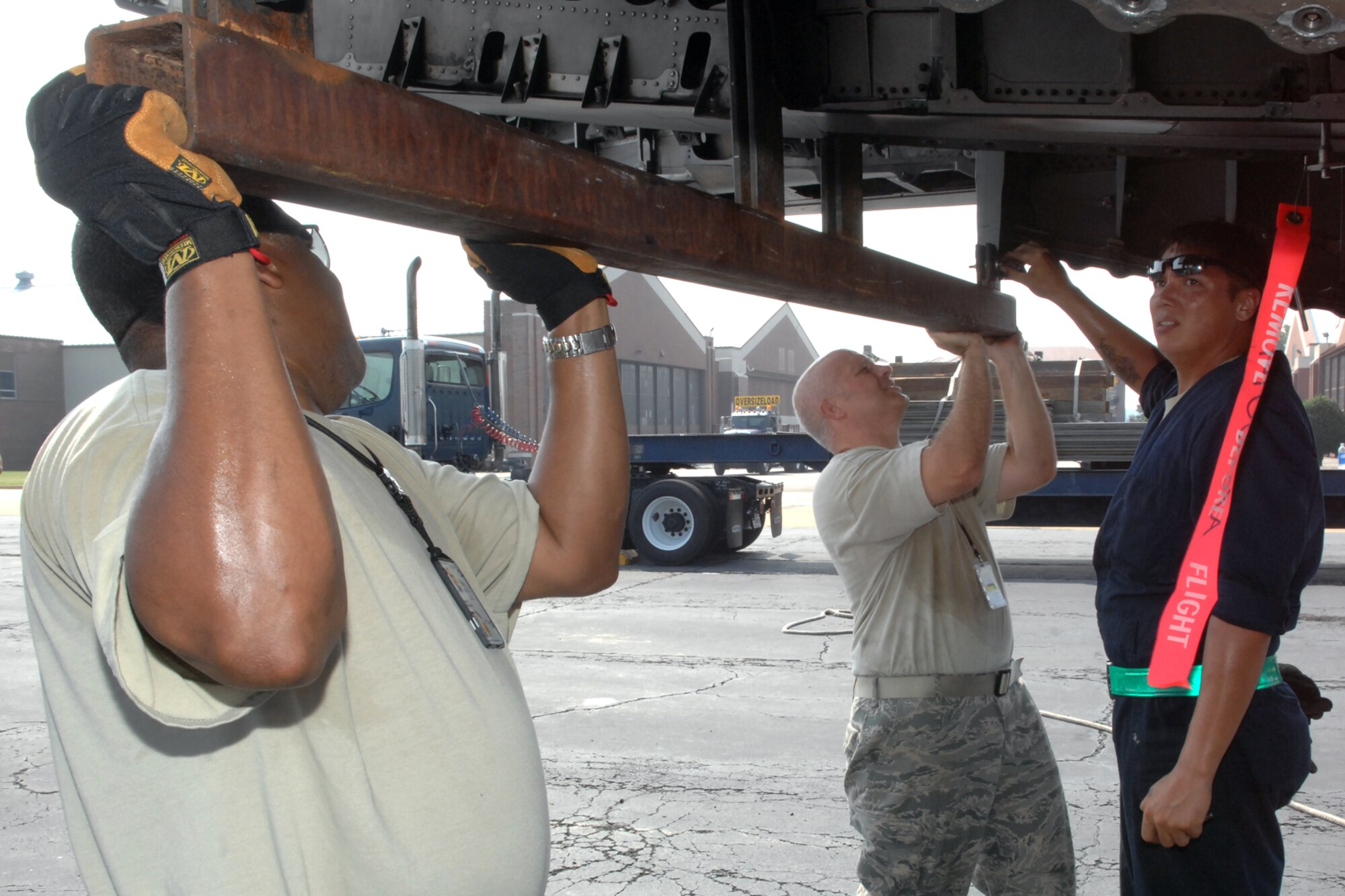 Master Sgt. Wildlando Handy, Tech. Sgt. Michael DiVietro and Staff Sgt. Joseph Burke, 1st Maintenance Squadron, Maintenance Flight, Package Maintenance and Plan team, secure a bracket to the tail of an F-15 Eagle July 21, at Langley Air Force Base, Va. The F-15 will be transported to the Chico Air Museum in Chico, Calif., where it will be on permanent display as part of the “Freedom Eagle” exhibit. (U. S. Air Force photo by Staff Sgt. Jeff Nevison/Released)
