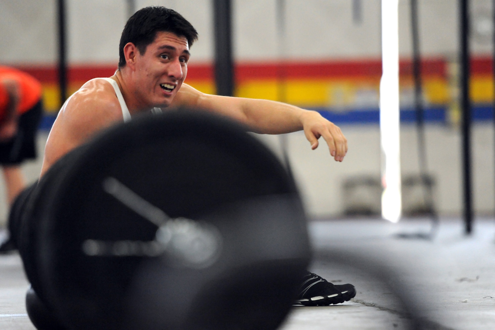 Staff Sgt. Allan Parra, of Brentwood, Long Island, N.Y., who serves with the 773rd Logistics Readiness Squadron, catches his breath during a CrossFit workout at Hangar 5 on Joint Base Elmendorf-Richardson after duty hours July 13.  Parra started doing CrossFit a few weeks ago after his wife, a long-term CrossFitter, encouraged him to get involved. (U.S. Air Force photo/Justin Connaher)