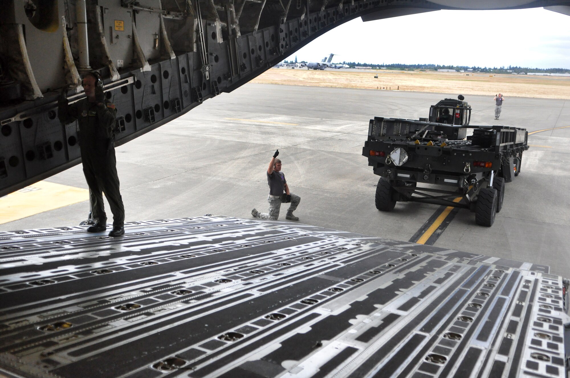 The 62nd Aerial Port Squadron Rodeo Team conducts a training drill July 19 at Joint Base Lewis-McChord, Wash. During their two months of training, the team practiced with the Rodeo Aircrew Team to conduct cargo on- and off-loading. Rodeo, sponsored by the Air Mobility Command, is the Mobility Air Force's readiness competition. This competition focuses on improving worldwide air mobility forces' professional core abilities.  (U.S. Air Force photo/Airman 1st Class Leah Young)