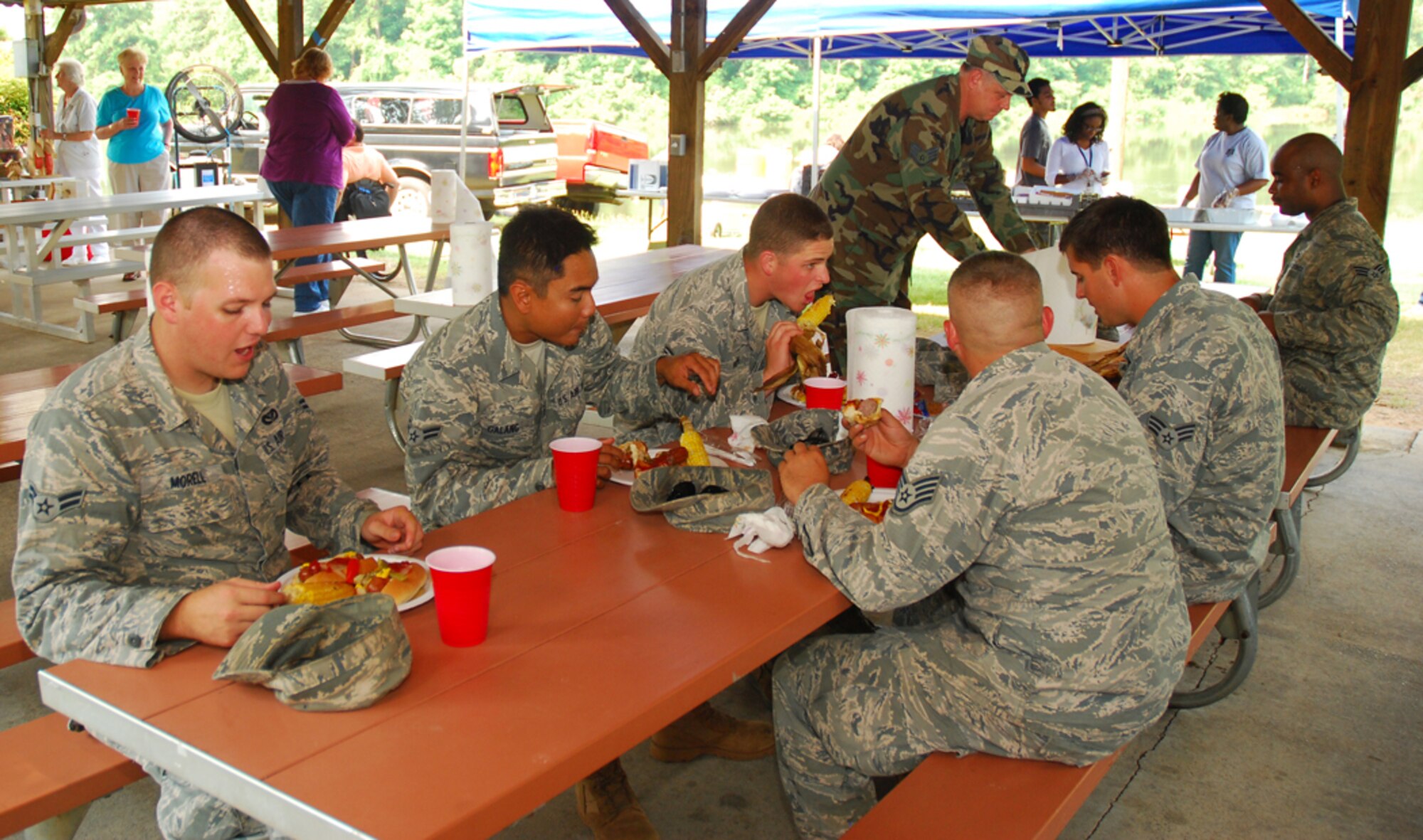 Attendees enjoy lunch at Lakeside Lounge July 20 for the 8th annual Corn and Sausage Roast. For $7, participants receive two bratwurst sausages, fresh corn, a beverage and dessert. Proceeds from the event go directly to the Dobbins Emergency Assistance Fund to assist reservists in financial need. (U.S. Air Force photo/Airman 1st Class Chelsea Smith
