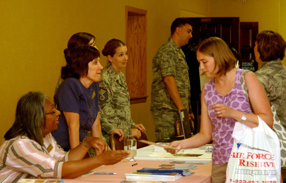 A spouse browses information about the Dakota’s Club during the Happy Landings orientation at Ellsworth Air Force Base, S.D., July 19, 2011.  Happy Landings was developed to enable Airmen and family members to meet with representatives from agencies across the base and local community and ask questions.  (U.S. Air Force photo/Airman Alessandra N. Gamboa/Released)