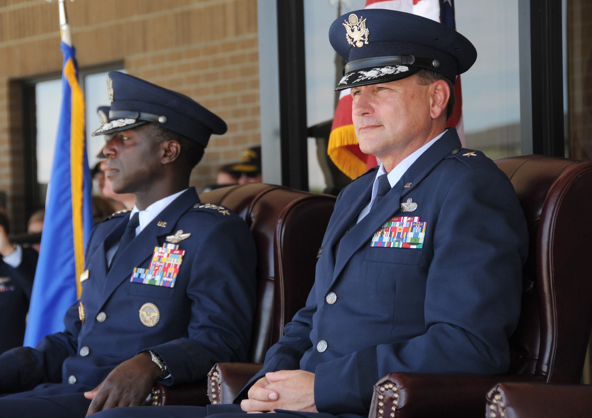 Gen. Edward Rice Jr., left, and Brig. Gen. Leonard Patrick watch the troops marching during pass and review following the 2nd Air Force change of command ceremony July 21 at Keesler Air Force Base, Miss.  Rice is commander of Air Education and Training Command and Patrick is the incoming 2nd Air Force commander.  (U.S. Air Force photo by Kemberly Groue)
