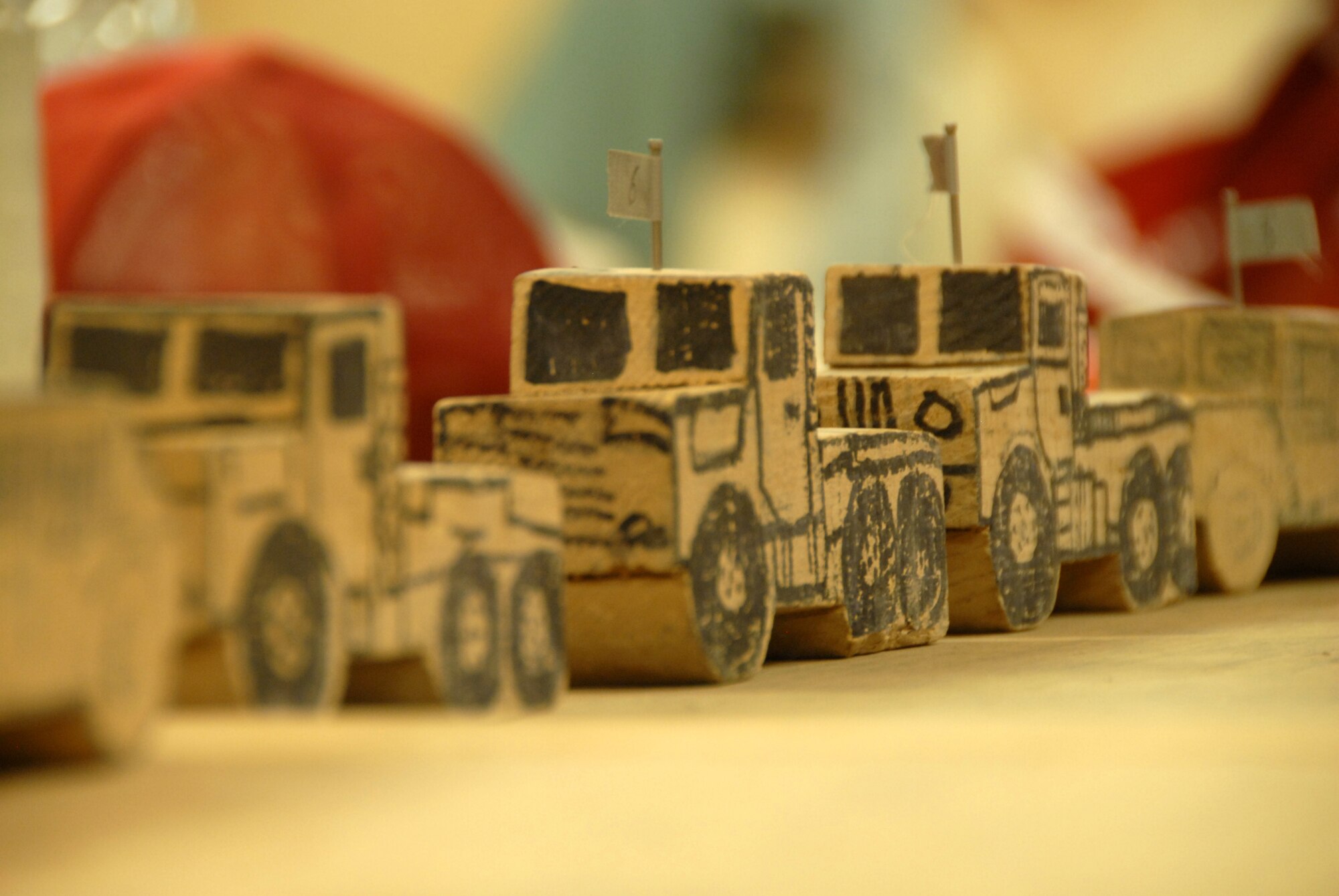 Model trucks, used to illustrate convoy scenarios, sit on a table in a briefing room of the 809th Expeditionary Rapid Engineer Deployable Heavy Operational Repair Squadron Engineers (RED HORSE) at Kandahar Airfield, Afghanistan on July 14, 2011. A RED HORSE team convoyed later in the day to pick up equipment that had been used to construct two runways in South East Afghanistan. (U.S. Air Force photo by Tech. Sgt. Emily F. Alley) 