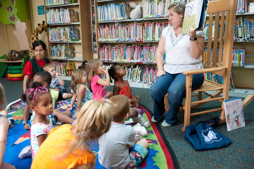 Sara Sesker,39th Force Support Squadron lead technician, reads to a group of 3-5 year olds from the Child Development Center July 22, 2011, at the library at Incirlik Air Base, Turkey.(U.S. Air Force photo by Airman 1st Class Clayton Lenhardt/Released)