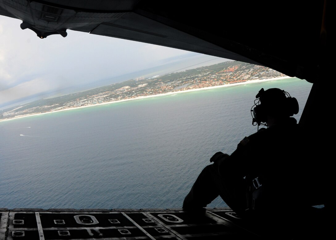 An Air Force Reserve loadmaster from the 711th Special Operations Squadron at Duke Field, Fla., scans the horizon off Destin, Fla., from the open ramp of an MC-130E Combat Talon I aircraft during a July 20 training mission.  The 711th SOS, part of the 919th Special Operations Wing, employs the Talon I in various covert roles including infiltration and exfiltration of special operations forces and aerial refueling in hostile or denied territory.  (U.S. Air Force photo/Tech. Sgt. Cheryl Foster)