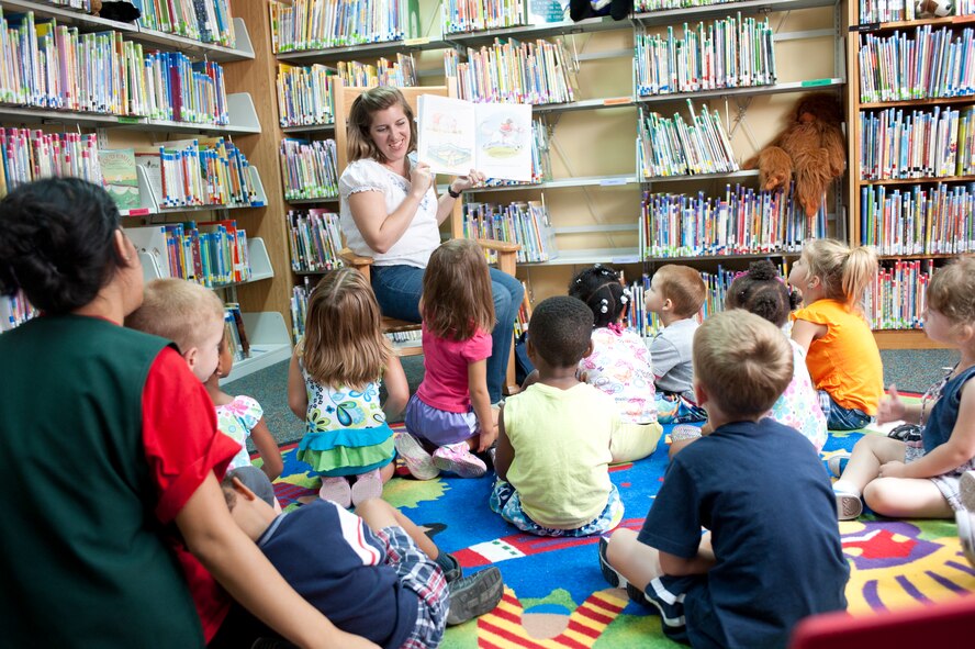 Sara Sesker,39th Force Support Squadron lead technician, reads to a group of 3-5 year olds from the Child Development Center July 22, 2011, at the library at Incirlik Air Base, Turkey.(U.S. Air Force photo by Airman 1st Class Clayton Lenhardt/Released)