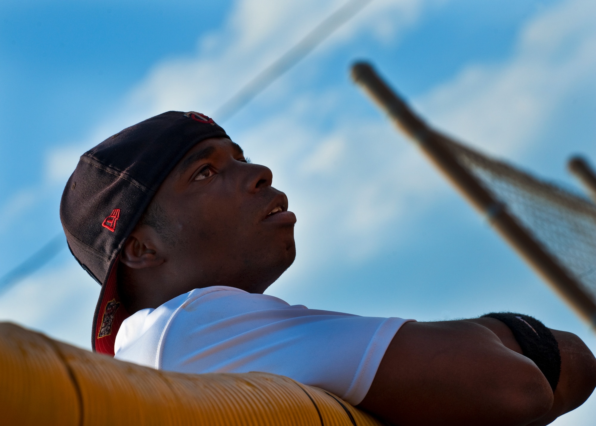 Myles Fair, of the 96th Security Forces Squadron, watches his team from the top of the fence during the intramural softball championship game against the 96th Medical Group at Eglin Air Force Base, Fla., July 20.  SFS came from behind in the final inning to take the championship 16-15.  (U.S. Air Force photo/Samuel King Jr.)
