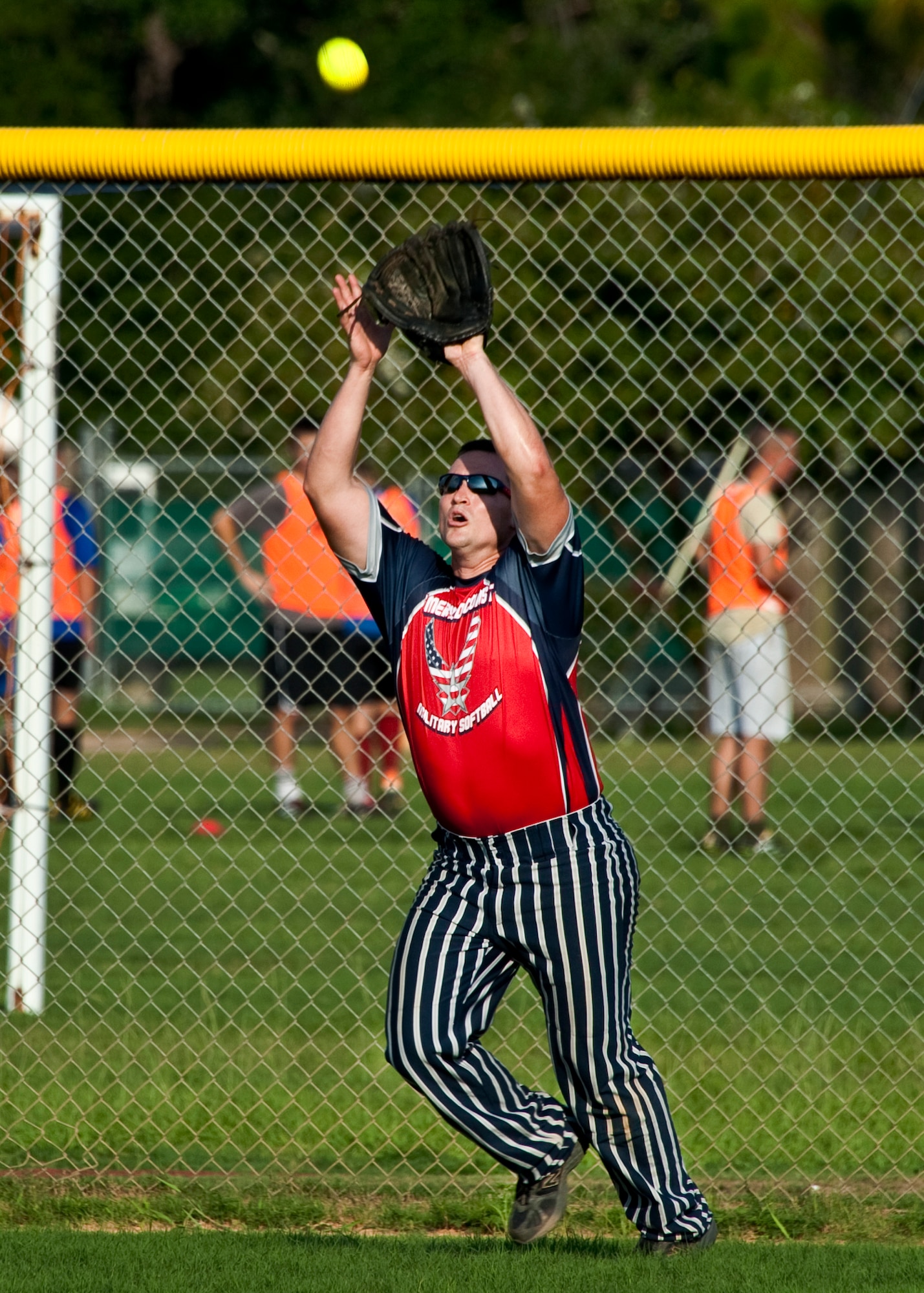 James Colbourne, of the 96th Security Forces Squadron, catches a fly ball at the wall during the intramural softball championship game against the 96th Medical Group at Eglin Air Force Base, Fla., July 20.  SFS came from behind in the final inning to take the championship 16-15.  (U.S. Air Force photo/Samuel King Jr.)