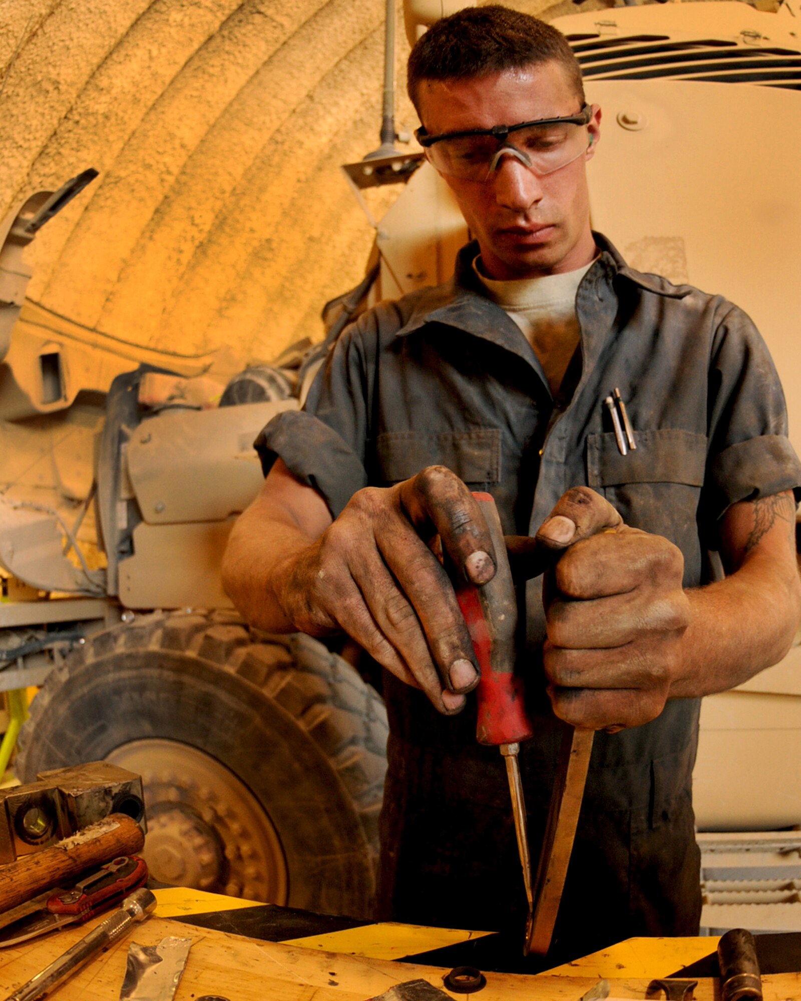 BAGRAM AIRFIELD, Afghanistan -- Staff Sgt. Daniel Hursey, 455th Expeditionary Logistics Readiness Squadron vehicle mechanic fixes an air actuator door for a MAXXPRO Mine Resistant Ambush Protected vehicle July 21, 2011. Hursey, stationed at Seymour Johnson Air Force Base, N.C., performs vehicle repairs and preventative maintenance daily. (U.S. Air Force photo/Senior Airman Krista Rose) 
