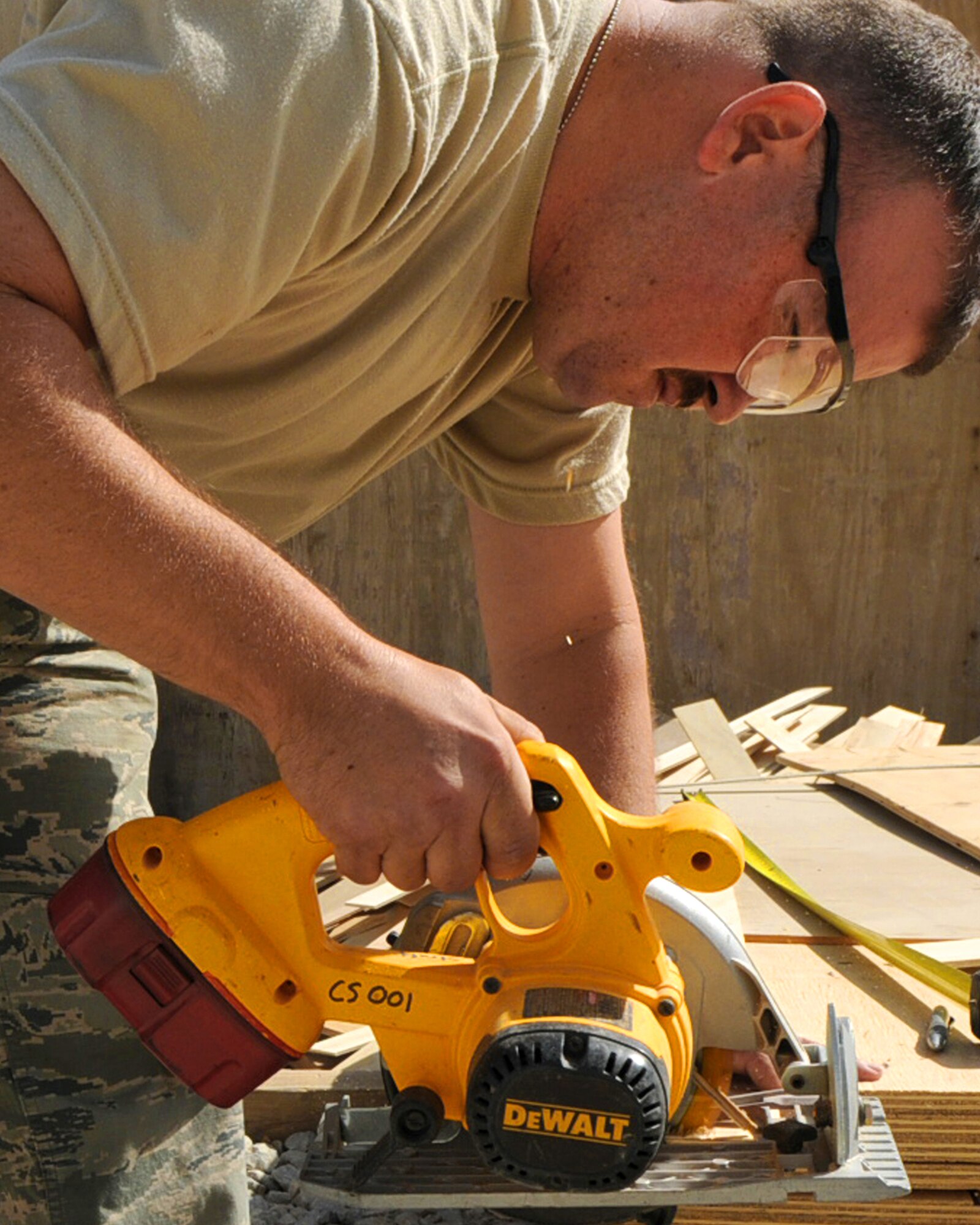 BAGRAM AIRFIELD, Afghanistan -- Staff Sgt. Timothy Mahon, 455th Expeditionary Civil Engineer Squadron utilities technician, saws wood for a project July 21, 2011. Mahon is working on a project to build a new flight medicine office. Mahon is deployed from the 121st Air Refueling Wing Air National Guard Base, Ohio. (U.S. Air Force photo/Senior Airman Krista Rose) 