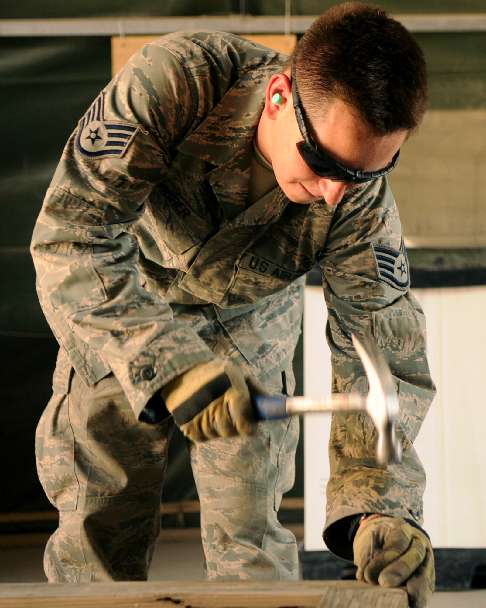 BAGRAM AIRFIELD, Afghanistan -- Staff Sgt. Brandon Fisher, 455th Expeditionary Logistics Readiness Squadron traffic management technician, seals a container to process a shipment July 21, 2011. After the pallets are moved into the processing line, they go through several different inspections before shipment. Fisher is stationed at Creech Air Force Base, Nev. (U.S. Air Force photo/Senior Airman Krista Rose) 