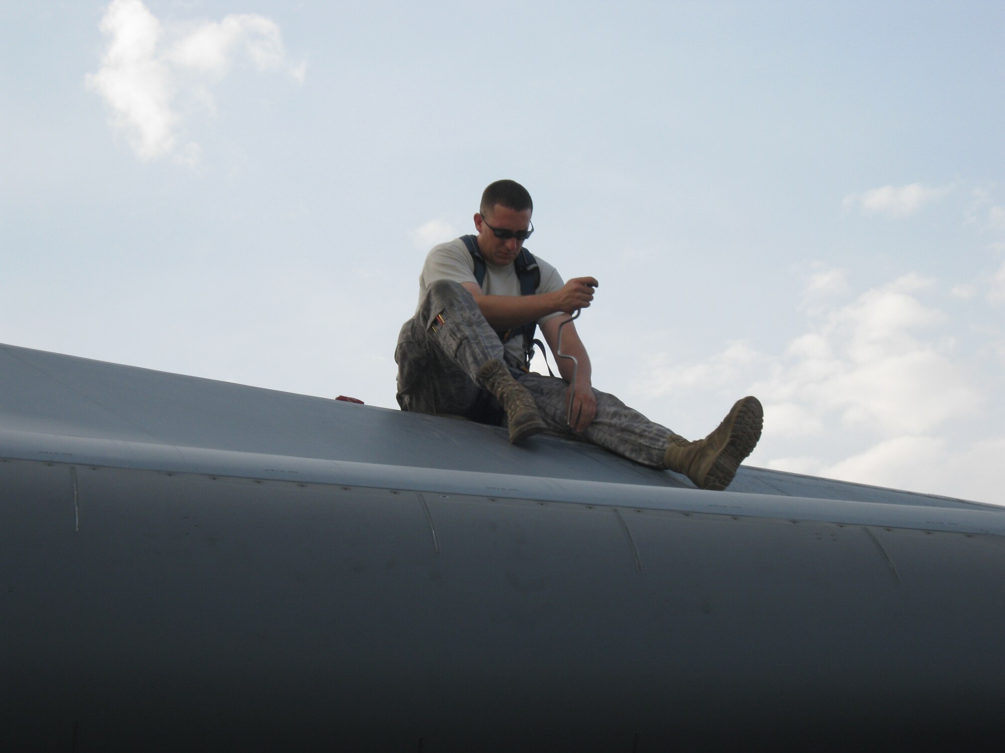 Staff Sgt. Jeremy Leclerc, 37th Aircraft Maintenance Squadron, tightens a screw on a panel of a B-1B Lancer at an undisclosed location in Southwest Asia, July 2.  The dedication of Leclerc and his 37th AMU teammates, ensures the aircraft is safe for its next mission. The 37th AMU won their sixth consecutive base-level 'AMU of the Month' award at the end of June. (U.S. Air Force photo/ Master Sgt. Christopher Garrettson)