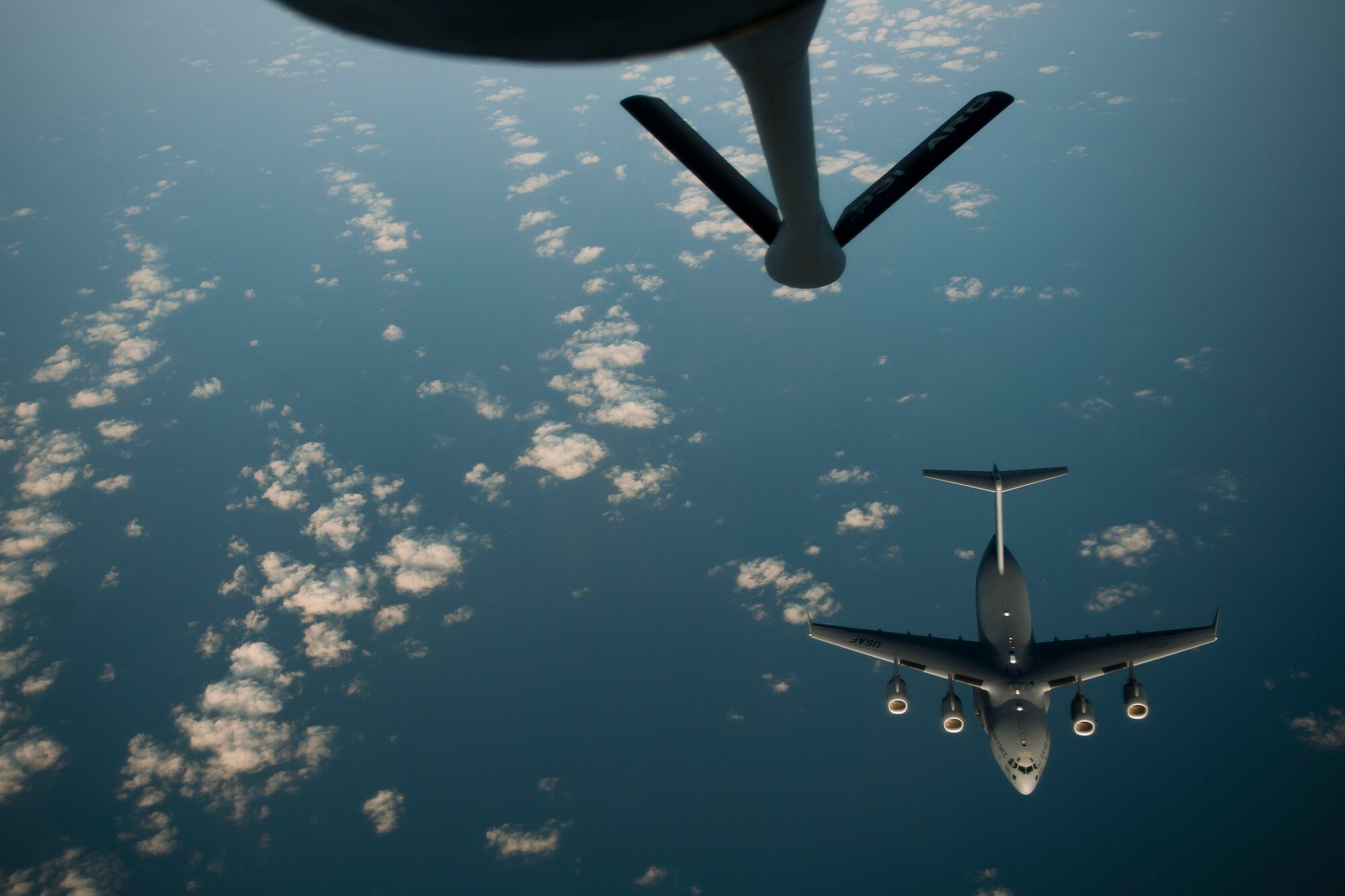 A C-17 Globemaster III aircraft disconnects from a 90th Expeditionary Air Refueling Squadron KC-135R Stratotanker aircraft during an air refueling training mission July 20, 2011, over the Black Sea north of Turkey. The 90th EARS, a total-force team consisting of nearly 100 active-duty, Reserve and Air National Guard Airmen, conducts air-to-air refuels to C-17 Globemaster IIIs and C-5 Galaxies coming in and out of the area of operations. (U.S. Air Force photo by Tech. Sgt. Michael B. Keller/Released)