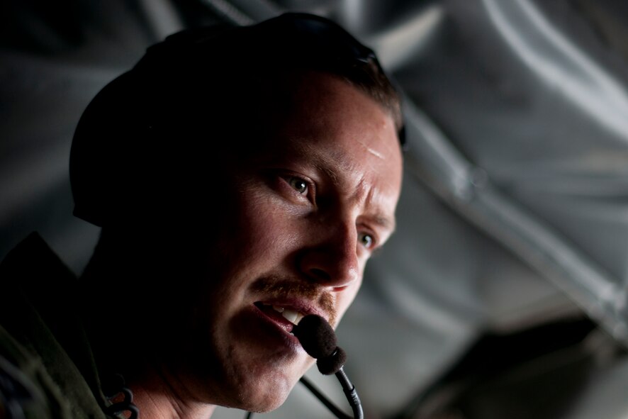 Capt. Chris Kidd, a 90th Expeditionary Air Refueling Squadron pilot, speaks with another crewmember onboard a KC-135R Stratotanker aircraft during an air refueling training mission July 20, 2011, over Turkey. The 90th EARS, a total-force team consisting of nearly 100 active-duty, Reserve and Air National Guard Airmen, conducts air-to-air refuels to C-17 Globemaster IIIs and C-5 Galaxies coming in and out of the area of operations. (U.S. Air Force photo by Tech. Sgt. Michael B. Keller/Released)