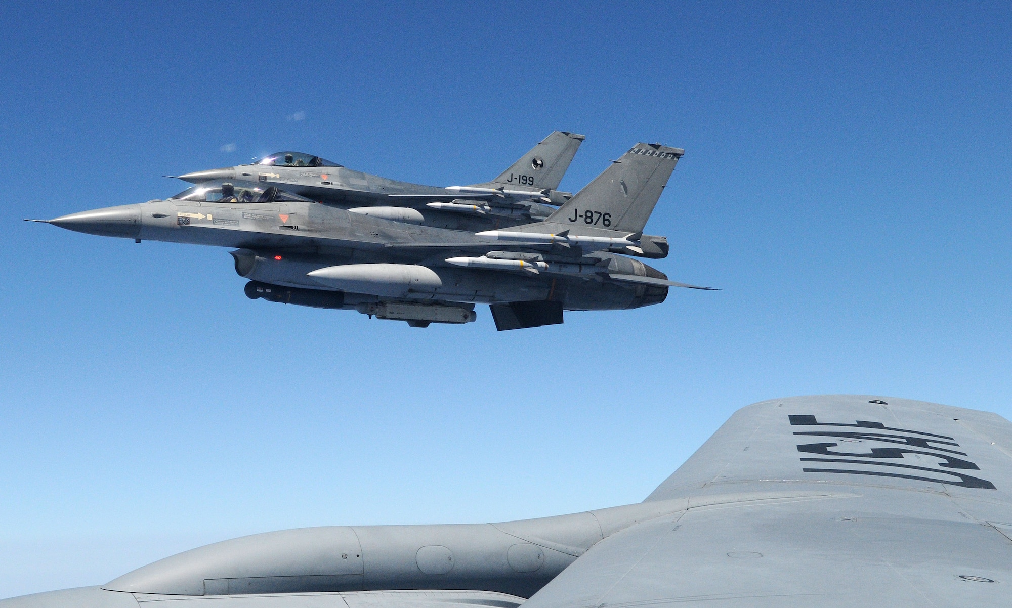 RAF MILDENHALL, England – Two Royal Netherlands Air Force F-16 Fighting Falcons sit in a holding position off the wing tip of a KC-135 Stratotanker from the 100th Air Refueling Wing over the Mediterranean Sea July 19, 2011. The F-16s received fuel from the KC-135 so that they may continue their mission in support of the NATO-led Operation Unified Protector. (U.S. Air Force photo/Staff Sgt. Thomas Trower)