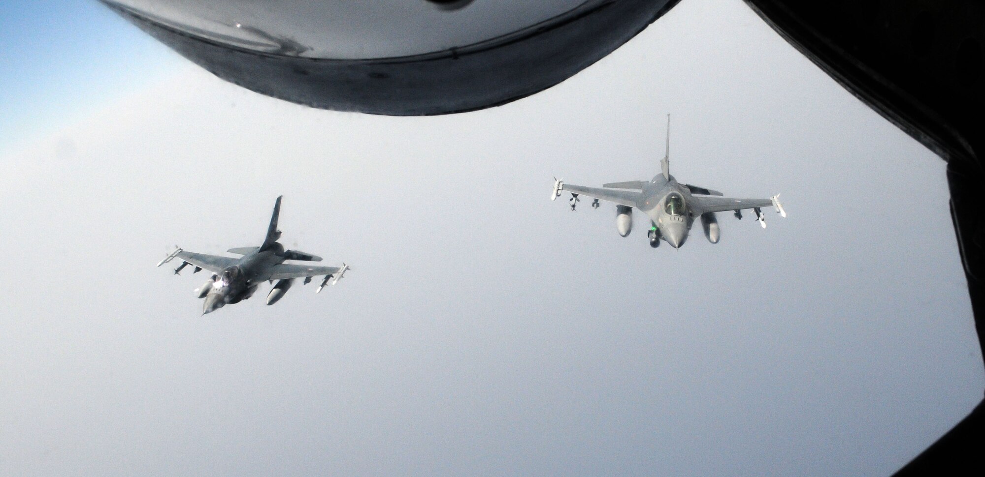 RAF MILDENHALL, England – Two Royal Netherlands Air Force F-16 Fighting Falcons fly in formation behind a KC-135 Stratotanker from RAF Mildenhall after receiving fuel to continue their mission in support of the NATO-led Operation Unified Protector July 19, 2011, over the Mediterranean Sea. The 100th Air Refueling Wing has flown more than 800 sorties in support of OUP. (U.S. Air Force photo/Staff Sgt. Thomas Trower)