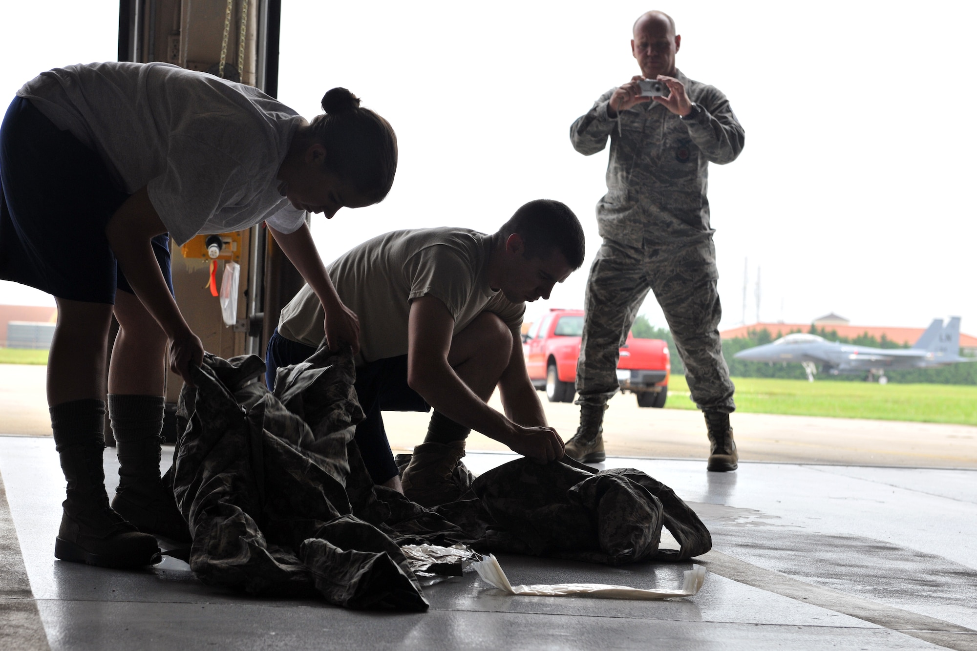 KUNSAN AIR BASE, Republic of Korea -- Airmen from the 8th Civil Engineer Squadron’s explosive ordnance disposal flight and emergency management flight, along with the 8th Medical Operations Squadron’s bioenvironmental engineering flight try on the Joint Firefighter's Integrated Response Ensemble Mod one-piece suit here July 22. Airmen were participating in a final field evaluation of the suit testing its design, fit and fabric. (U.S. Air Force photo/Senior Airman Brittany Y. Bateman)