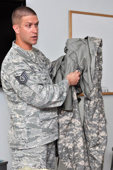 KUNSAN AIR BASE, Republic of Korea -- Tech. Sgt. Thomas Ryan, Detachment 1 823rd Red Horse Squadron fire contingency instructor at Tyndall Air Force Base, Fla., demonstrates how to wear the Joint Firefighter's Integrated Response Ensemble Mod one-piece suit to Airmen from the 8th Civil Engineer Squadron’s explosive ordnance disposal flight and emergency management flight, along with the 8th Medical Operations Squadron’s bioenvironmental engineering flight here July 22. (U.S. Air Force photo/Senior Airman Brittany Y. Bateman)