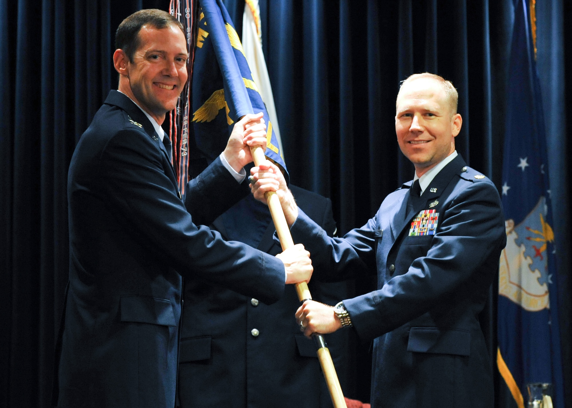 YOKOTA AIR BASE, Japan -- Col. Todd Freece, 374th Mission Support Group commander, passes the 374th Logistics Readiness Squadron guidon to Maj. Brandon Maroon, 374th LRS commander at Yokota Air Base, Japan, July 20, 2011. Receiving the unit guidon symbolizes Major Maroon's assumption of command. (U.S. Air Force photo/Airman 1st Class Krystal M. Garrett) 