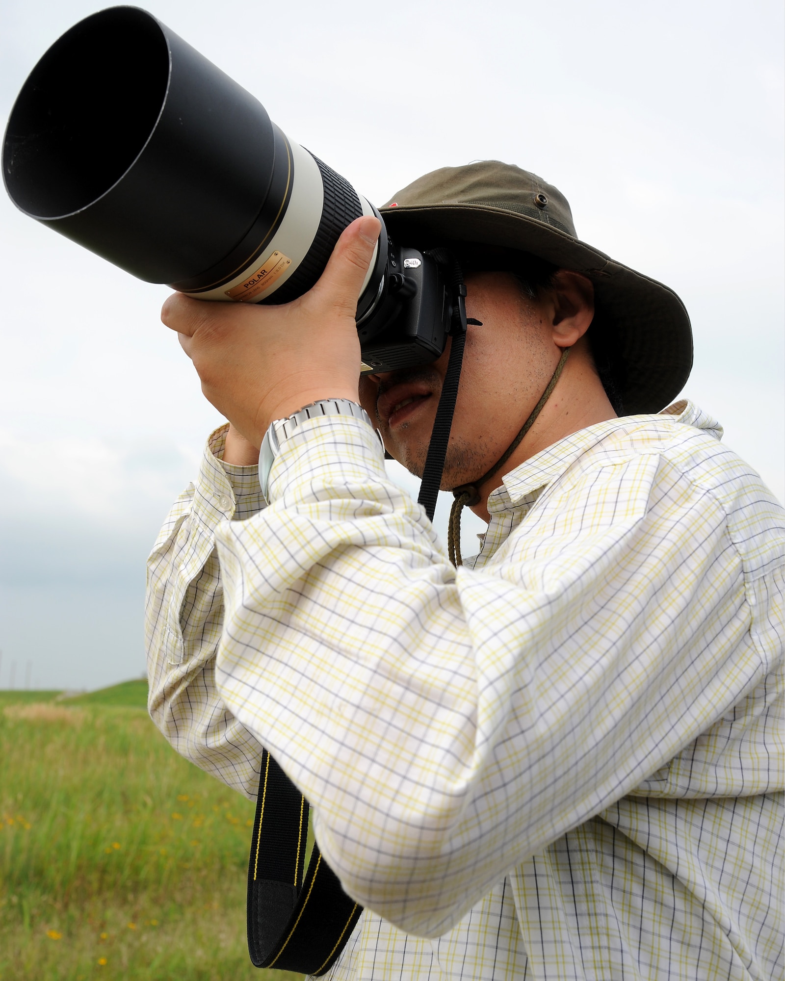 KUNSAN AIR BASE, Republic of Korea -- Suk Kyu Kim, a biology doctorate student at Kunsan National University in Gunsan City, takes photographs for a migratory avian survey being held here July 21. (U.S. Air Force photo/Staff Sgt. Rasheen A. Douglas)
