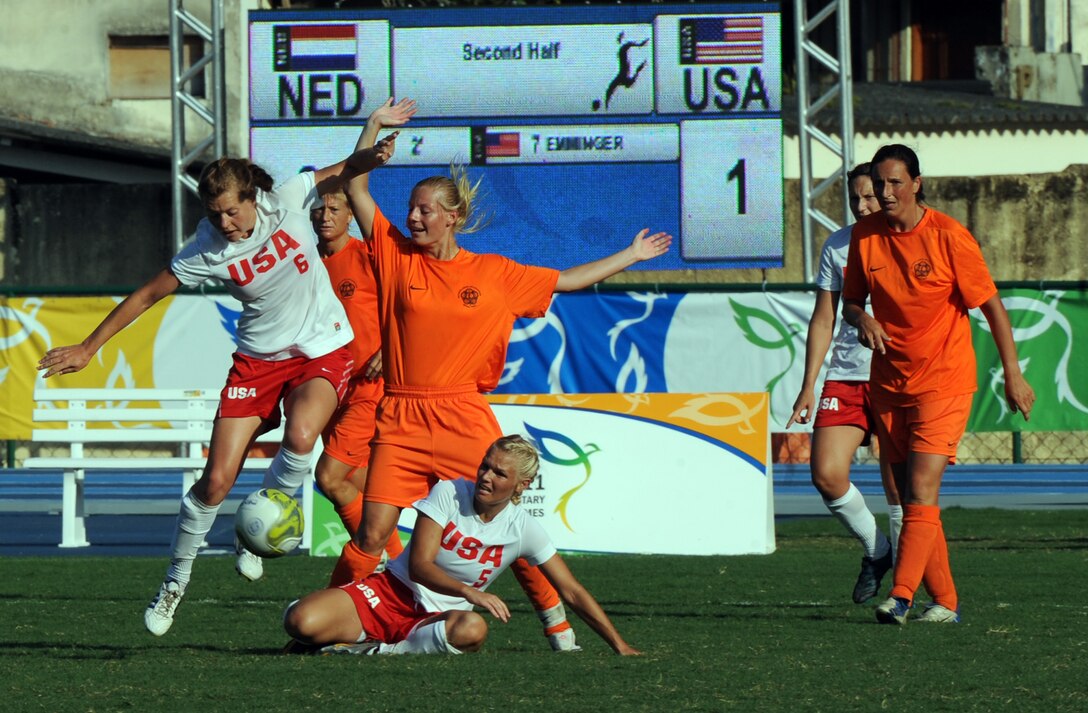 Military Team USA soccer players Air Force 2nd Lt. Rachel Emory, left, and Air Force Capt. Brittney Perkowski battle Netherlands for possession of the ball during Team USA's 1-0 victory at the Counseil International du Sport Militaire's 5th Military World Games in Rio de Janeiro, July 20, 2011.