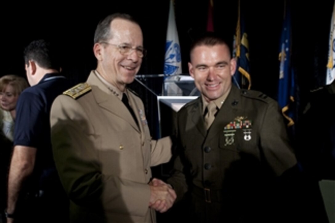 Chairman of the Joint Chiefs of Staff Adm. Mike Mullen greets U.S. Marine Corps Capt. David J. Cote at the 2011 Military Times Service Members of the Year Awards Ceremony at the Cannon House Office Building in Washington, D.C., on July 21, 2011.  Cote was selected at the U.S. Marine Corps representative for the award.  