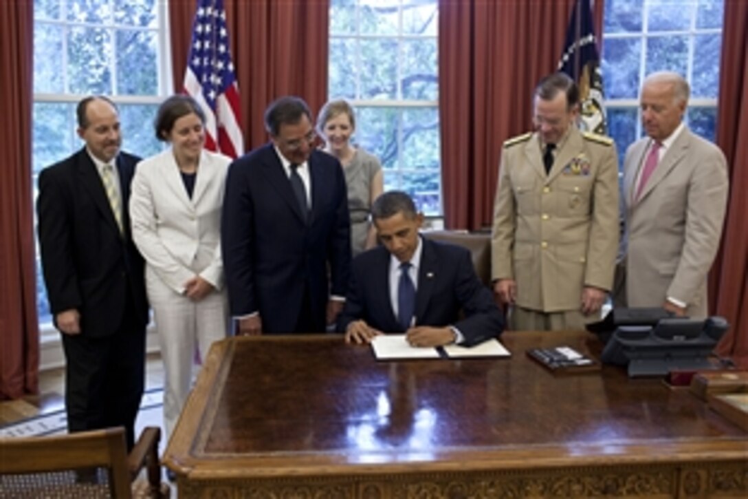 President Barack Obama signs the certification for the repeal of the "Don't Ask, Don't Tell" law in the Oval Office in the White House, July 22, 2011. Pictured, from left, are: Brian Bond, deputy director of the Office of Public Engagement; Kathleen Hartnett, associate counsel to the president; Defense Secreteary Leon E. Panetta; Kathryn Ruemmler, counsel to the president; Navy Adm. Mike Mullen, chairman of the Joint Chiefs of Staff, and Vice President Joe Biden.