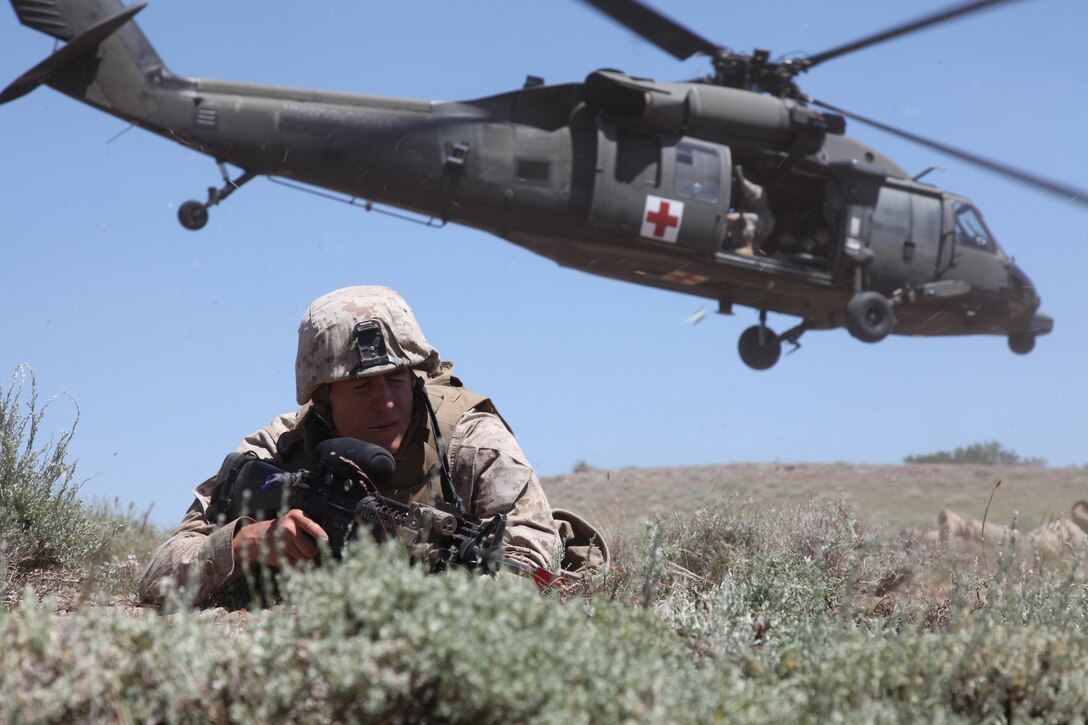 Cpl. Nicholas Borcherding, a fire team leader with 2nd Battalion, 24th Marine Regiment and Davenport, Iowa, native, braces as a UH-60 Blackhawk from the California National Guard’s 1/168th General Support Aviation Battalion takes off, July 23, 2011. The National Guardsmen taught the Marines how to do a proper medical evacuation as they trained for their final exercise during Javelin Thrust.