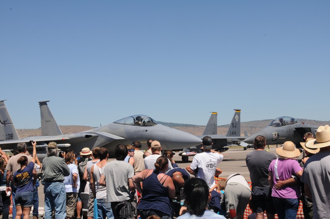 A crowd watches as an F-15 Eagle from the 120th Fighter Wing, Montana Air National Guard, taxis by during the 14th biennial Sentry Eagle Open House at Kingsley Field, Klamath Falls, Ore. July 23, 2011.  (U.S. Air Force photo by Tech. Sgt. Jennifer Shirar)