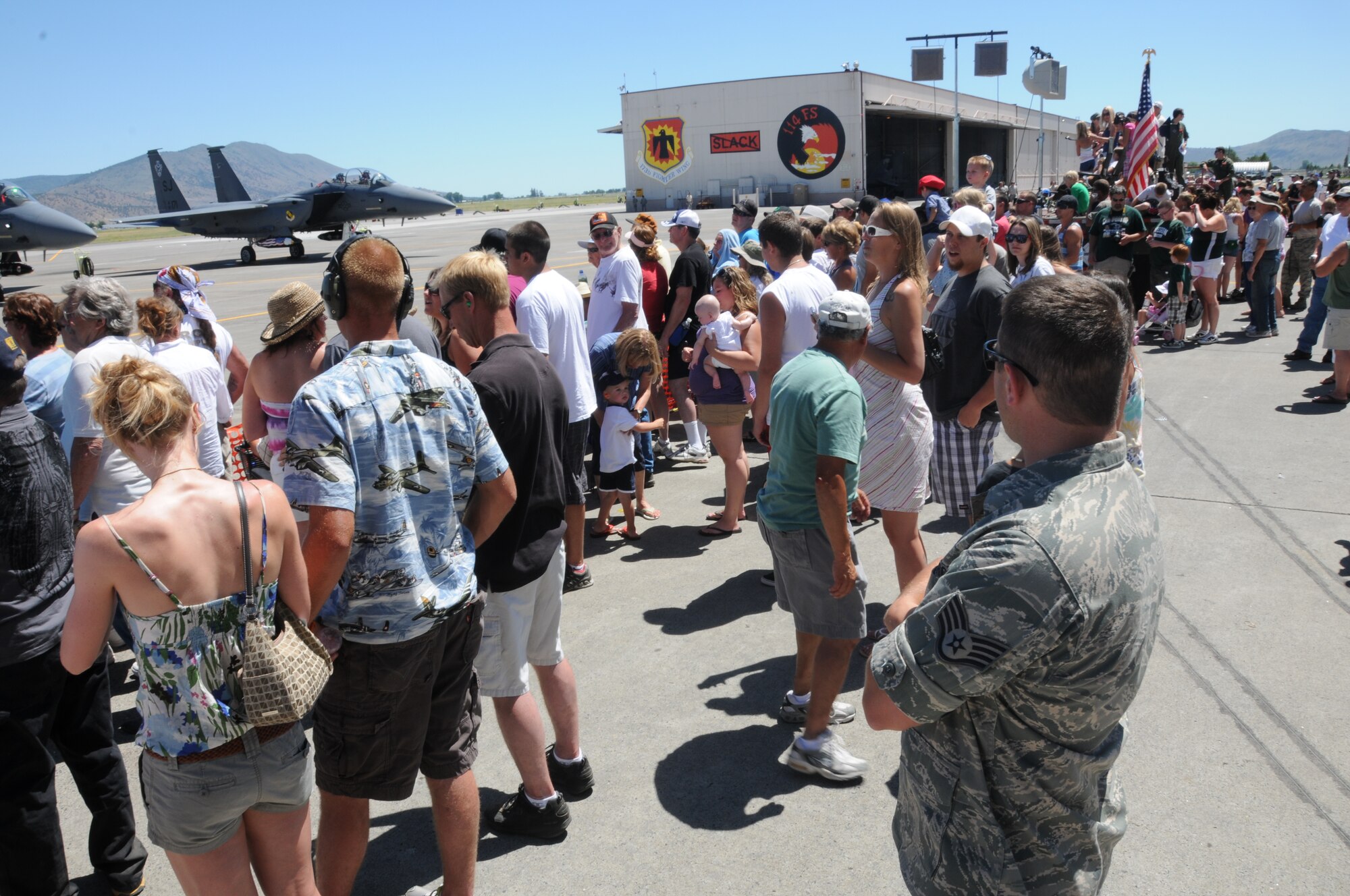 A crowd gathers at the flightline  edge to watch as ground crews prepare their aircraft for launch during the 14th biennial Sentry Eagle Open House at Kingsley Field, Klamath Falls, Ore. July 23, 2011.  (U.S. Air Force photo by Tech. Sgt. Jennifer Shirar)