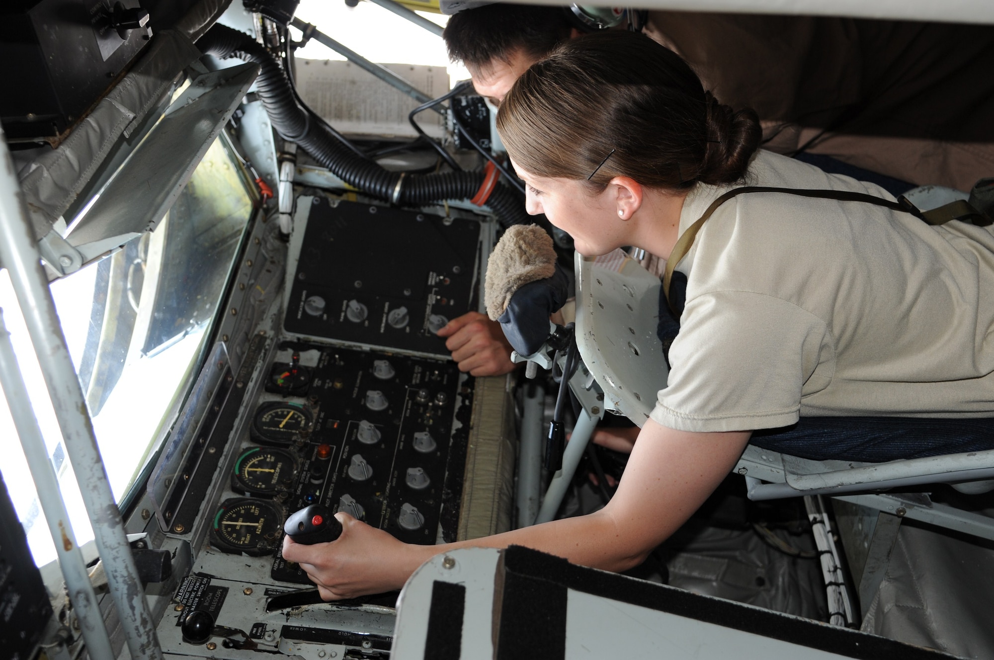 Airman 1st Class Jenny Proctor receives instructions from Staff Sgt. Alan Champagne on how to operate a KC-135 Stratotanker boom over Kyrgyzstan during an incentive flight July 22. Proctor is a member of the 376th Logistics Readiness Squadron commander’s support staff. She is deployed to the Transit Center at Manas from Hill Air Force Base, Utah. Champagne is a boom operator assigned to the 22nd Expeditionary Air Refueling Squadron. He is deployed here from Fairchild Air Force Base, Wash. (U.S. Air Force photo/Tech. Sgt. Hank Hoegen)