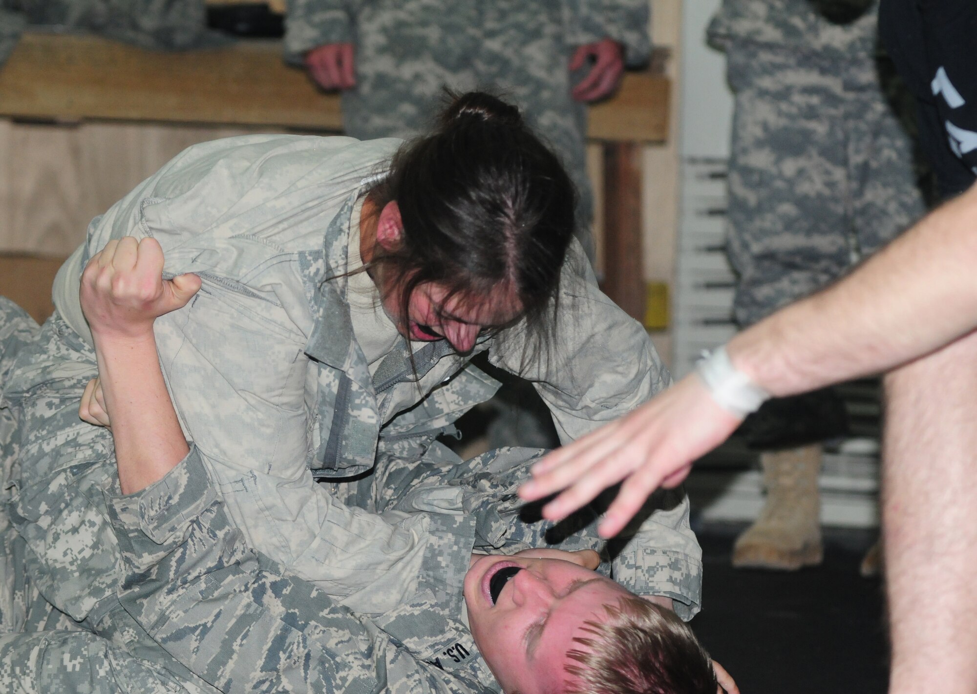Spc. Lindsay Schneider, competes in the final tournament of a weeklong Modern Army Combatives Program course at the 380th Air Expeditionary Wing in Southwest Asia, July 22, 2011. This course teaches basic ground technique and how to maintain a dominant position, simple submissions, gain a clinch and subdue a striking opponent. Schneider is a communication relay group crew member with the 3rd Battalion, 4th Air Defense Artillery Regiment deployed from Fort Bragg, N.C.  (U.S. Air Force photo/1st Lt. Gina McKeen)