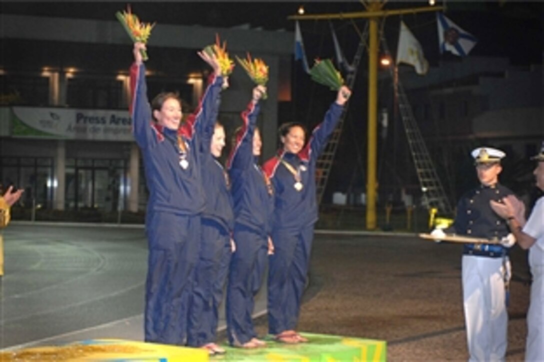 The U.S. women's sailing team celebrates after receiving their bronze medal in the women's division of the fleet sailing event July 22, 2011, at the 5th International Military Sports Council's World Games in Rio de Janeiro, Brazil. Pictured are, from left to right, Coast Guard Lts. Elizabeth Tufts and Nicole Auth, Navy Ensign Emily Frost and Coast Guard Lt. Krysia Pohl. Not pictured on the team is Marine Corps Maj. Frances Clemens. 