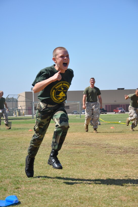 Gung-ho little marine goes for it as the big Marine mentoring him shouts encouragement.