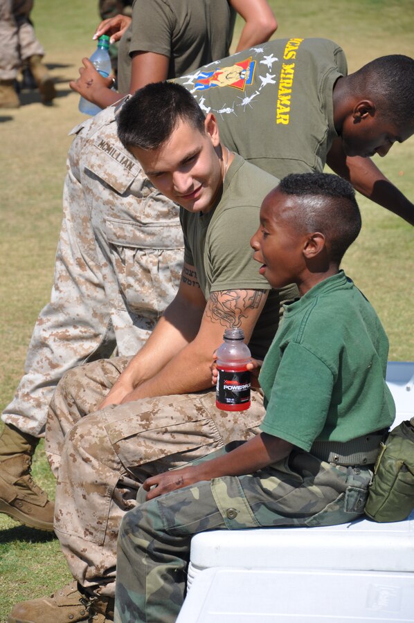A Miramar Marine takes time to mentor a Young Marine during the Big Marine, little marine competition held aboard Marine Corps Air Station Miramar July 23.
