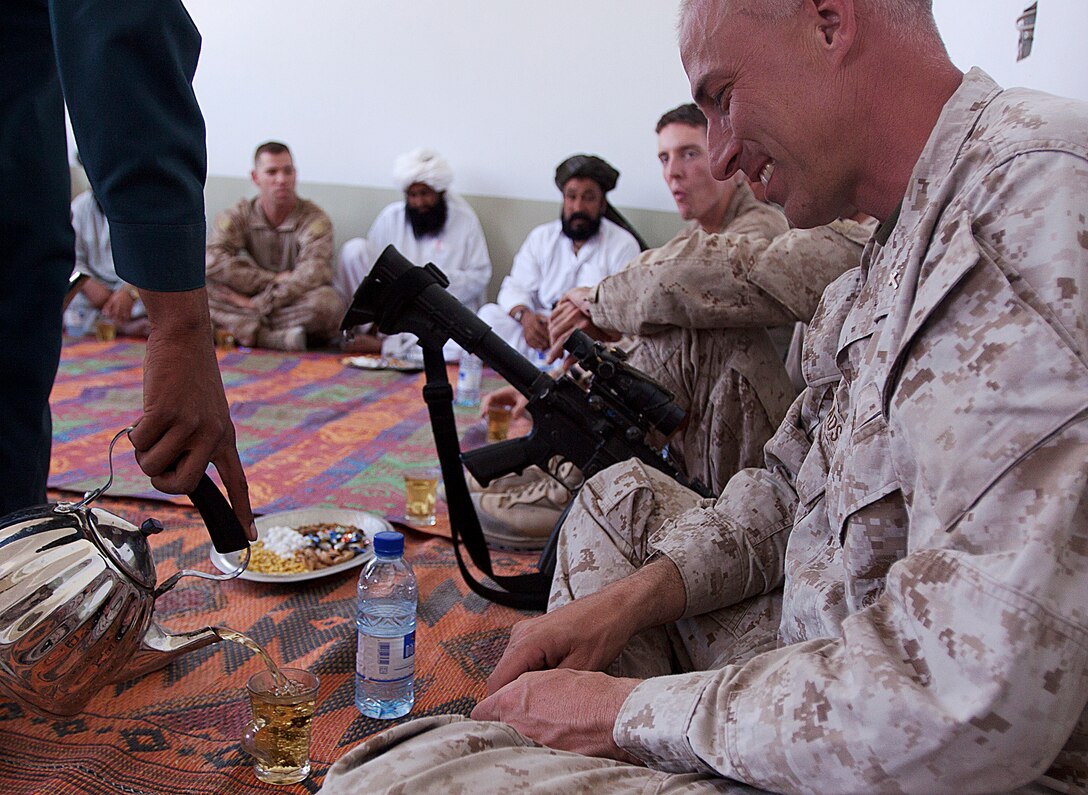 Navy Lt. Carl Rhoads enjoys a cup of chai tea during a shura with local mullahs here, July 23. Rhoads, a native of Weippe, Idaho, is the battalion chaplain for 1st Battalion, 3rd Marine Regiment. The shura was held to connect with local mullahs in Garmsir and find out different ways to support the local community.