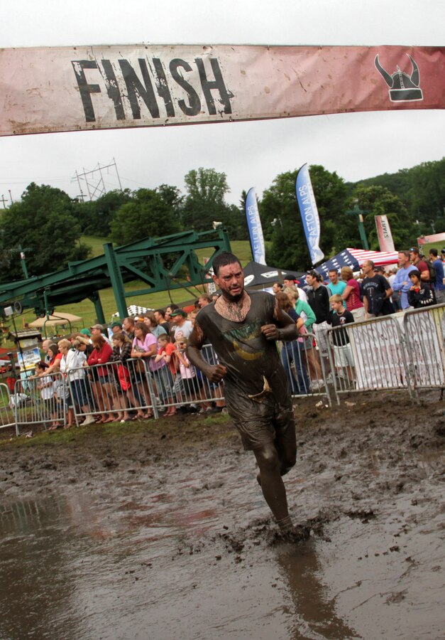 A Warrior Dash participant makes his way past the finish line during Sunday's race, which drew more than 8,900 competitors. Saturday's race drew nearly 10,500 athletes. The top finisher was 25-year-old Jason Quarford who completed the course with a 7:31 pace per mile. For more information about the event, visit www.warriordash.com.