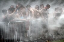 Warrior Dash competitors receive a complimentary hose-down after completing the 3.2-mile course July 24. Provided they were present at the awards ceremony, the top three male and female participants in each age division received helmets for their efforts. Other awards included most ridiculous costume and best warrior beard. For more information about the event, visit www.warriordash.com.