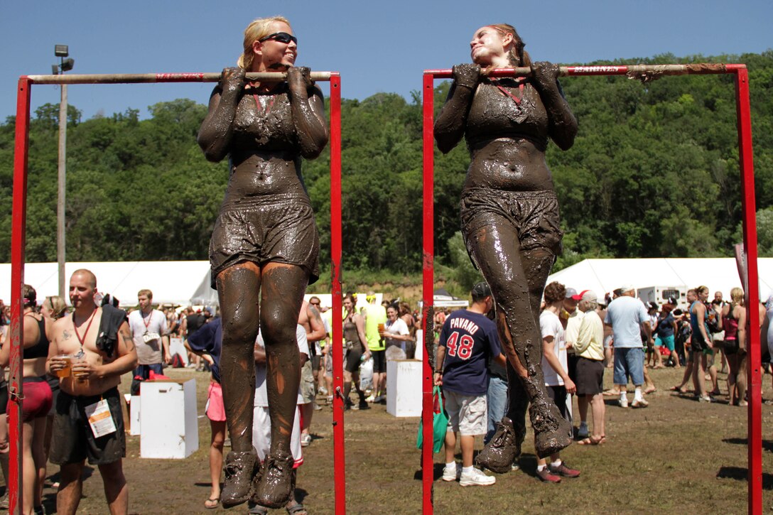 Aspiring Marines from Recruiting Substation Burnsville look to each other for motivation after completing the Warrior Dash July 23. Both ladies completed the 3.2-mile course in under 50 minutes. The top female finisher that day was 30-year-old Carrie Nitz, who crossed the finish line in 55th place with a time of 27:53.60. For more information about the event, visit www.warriordash.com.