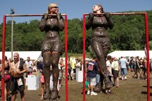 Aspiring Marines from Recruiting Substation Burnsville look to each other for motivation after completing the Warrior Dash July 23. Both ladies completed the 3.2-mile course in under 50 minutes. The top female finisher that day was 30-year-old Carrie Nitz, who crossed the finish line in 55th place with a time of 27:53.60. For more information about the event, visit www.warriordash.com.