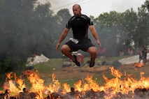 Mathew Mann, 30, leaps over the Warrior Roast obstacle while racing toward the Warrior Dash finish line July 24. Mann finished the race in 122nd place with a time of 28:22.45. He was 20th in his age group. More than 19 thousand people completed the 3.2-mile course. For the top race times or more information about the event, visit www.warriordash.com.