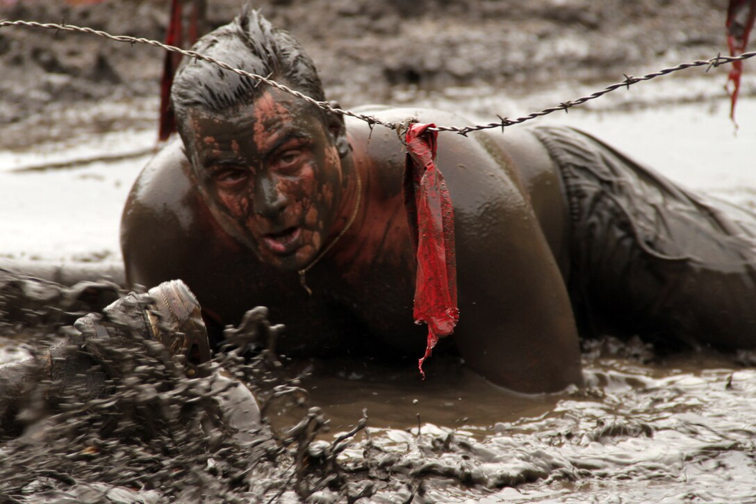A Warrior Dash participant looks for the finish line on July 24 during the last obstacle called Muddy Mayhem. Runners had to complete twelve obstacles along the 3.2-mile course before crossing the finish line. The fastest runner completed the endurance race in 22:42.90. For more information about the event, visit www.warriordash.com.