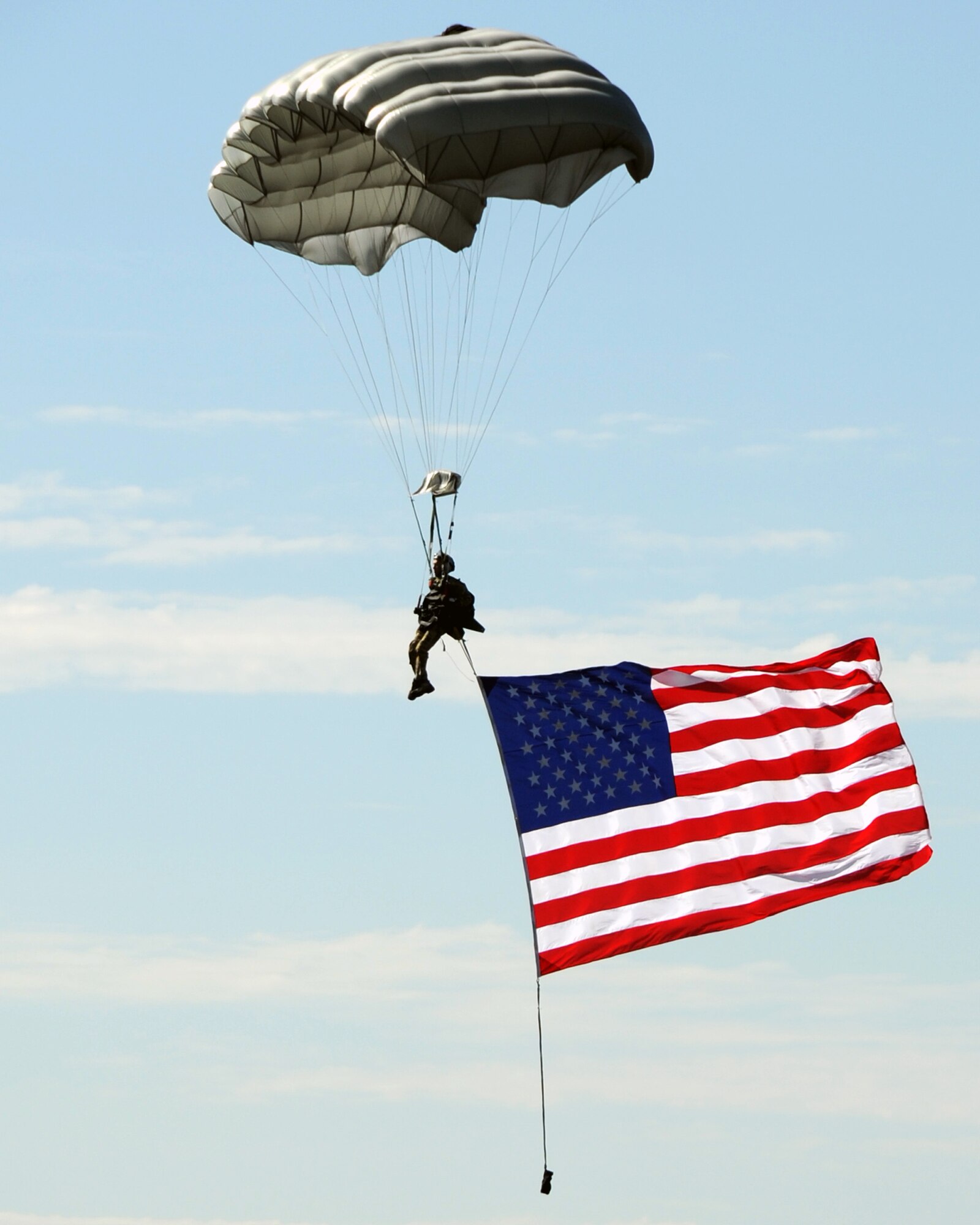 JOINT BASE LEWIS-MCCHORD, Wash. – An Airman parachutes to the ground from a C-17 Globemaster III while streaming an American Flag during the opening ceremony of the 2011 Air Mobility Command Rodeo July 24, 2011. Air Mobility Rodeo is the U.S. Air Force's and Air Mobility Command’s premier international combat skill and flying operations competition designed to develop and improve techniques, procedures and interoperability, while optimizing international mobility partnerships and enhancing mobility operations. (U.S. Air Force photo by Airman 1st Class Kenneth W. Norman / Released / 97th Air Mobility Wing Rodeo Public Affairs)