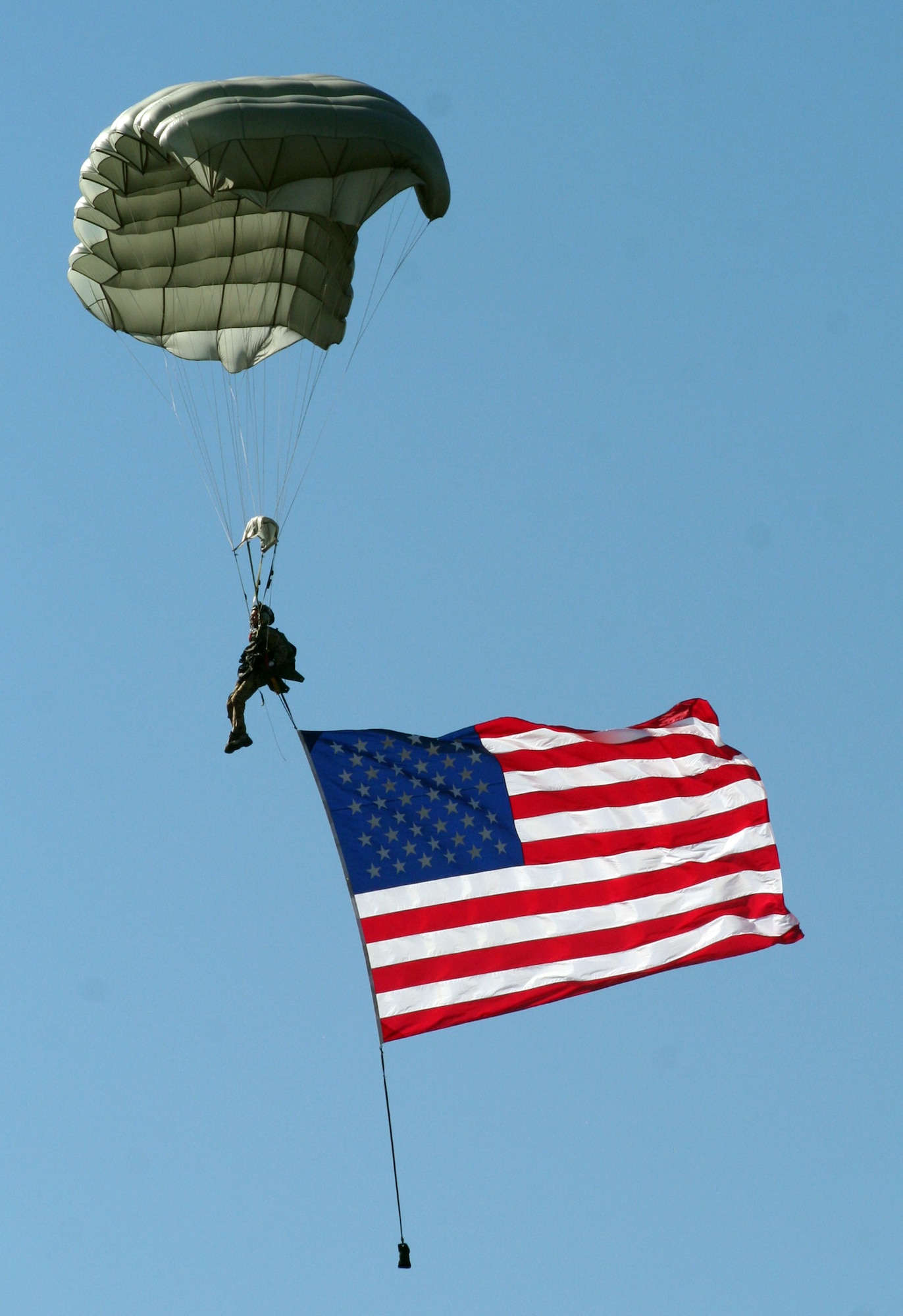 A special tactics parachutist descends toward the Earth with the American flag during the opening ceremonies for Air Mobility Rodeo 2011 at Joint Base Lewis-McChord, Wash., on July 24, 2011. (U.S. Air Force Photo/Master Sgt. Scott T. Sturkol)