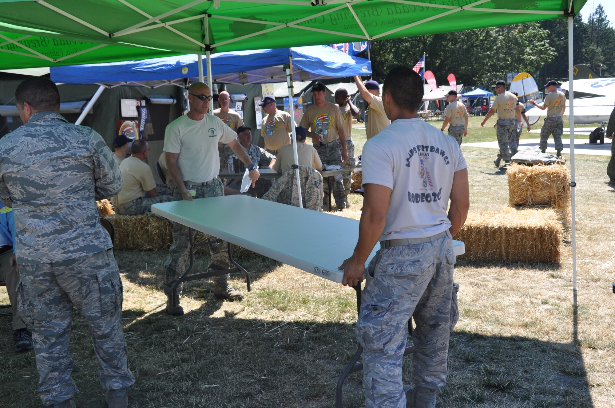 Members of Travis Air Force Base's 60th Air Mobility Wing, assemble tables for the Team Travis Air Mobility Rodeo 2011 hospitality tent July 24, 2011 at Rainer Ranch, which is an international meeting place for rodeo participants and spectators at Joint Base Lewis-McChord, Wash. (U.S. Air Force photo/Airman 1st Class Michael Battles)