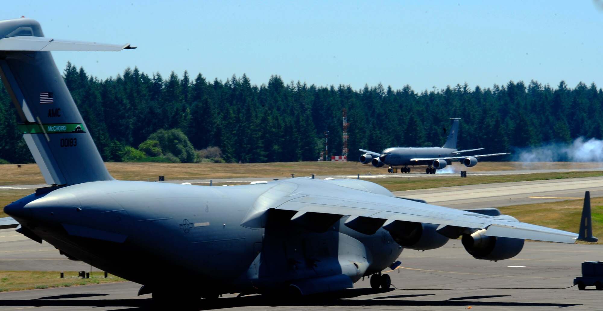 A Fairchild Air Force Base KC-135R Stratotanker lands at Joint Base Lewis-McChord, Wash., for the Air Mobility Rodeo 2011 competetion July 23, 2011. Rodeo is a biennial international competition that focuses on mission readiness, featuring airdrops, aerial refueling and other events that showcase the skills of mobility crews from around the world. A McChord C-17 Globemaster III sits on the flightline in the foreground; Washington State's highest peak, Mt. Rainier, stands in the background. (U.S. Air Force photo/ Staff Sgt. J.G. Buzanowski)